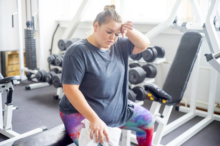 A woman takes a break while exercising.