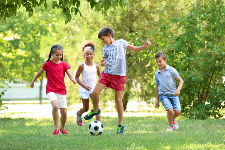 Children playing football in the park.