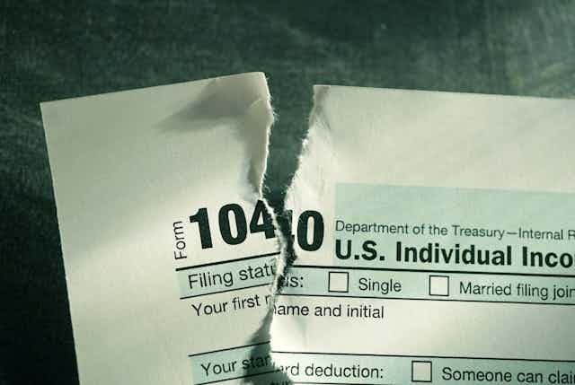 A torn-up copy of IRS tax form 1040.