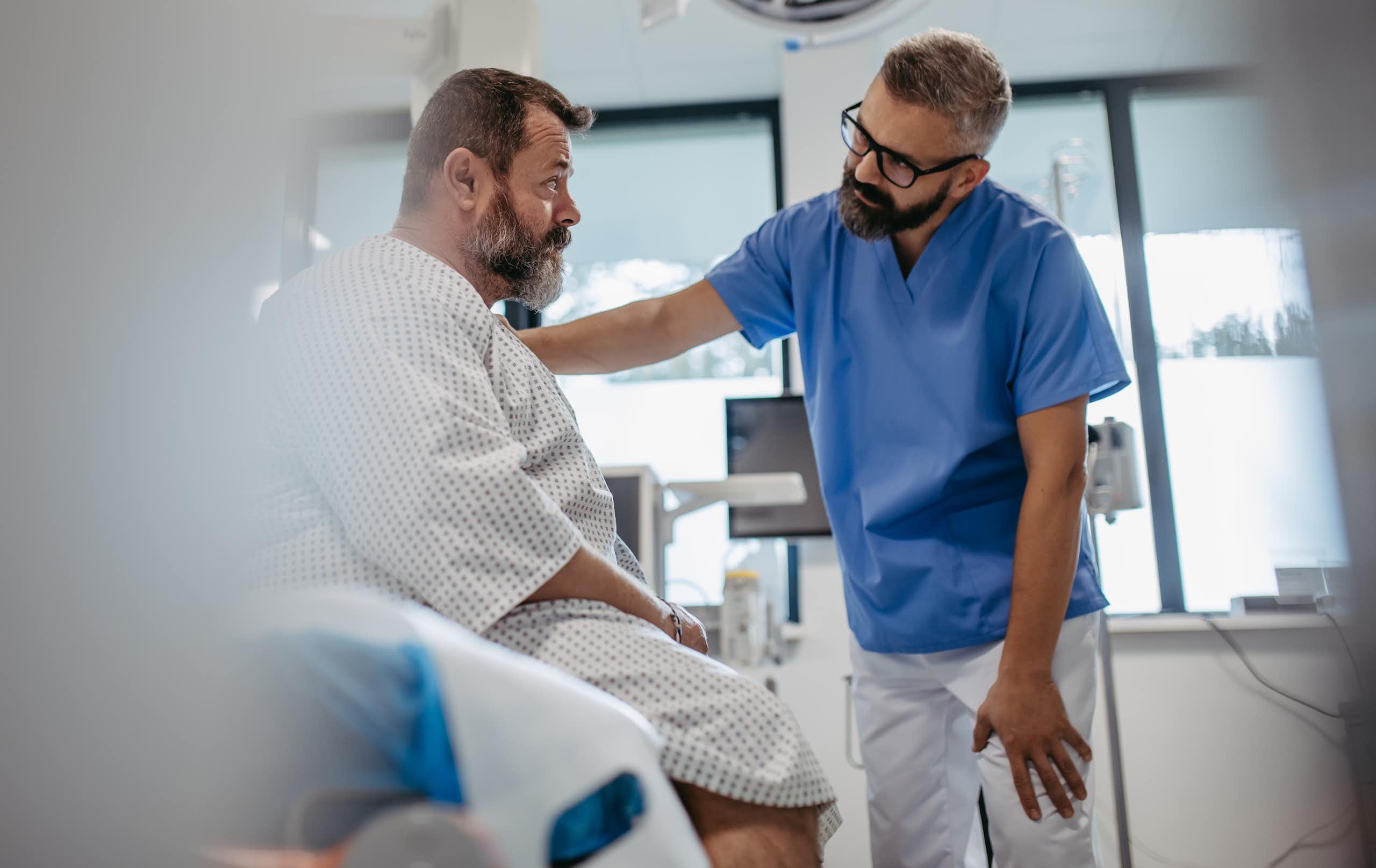 Clinician talks to patient