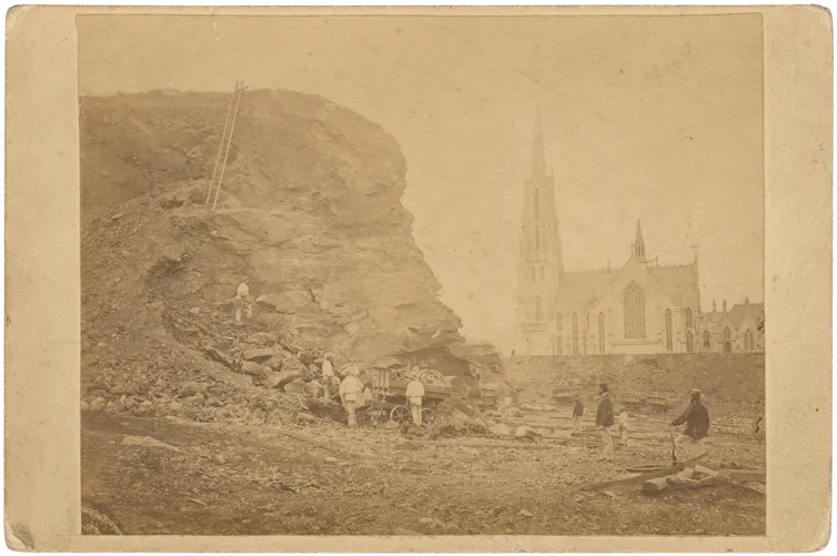 Old sepia photograph of Bell Hill, Dunedin, with church in background.