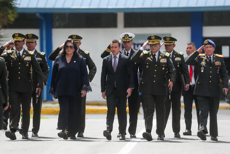 Ecuadorean president Daniel Noboa with an escort of police officers, January 2024.