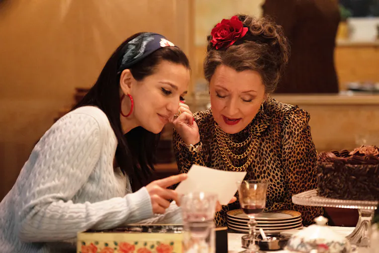 Amy and her grandmother looking at photographs.