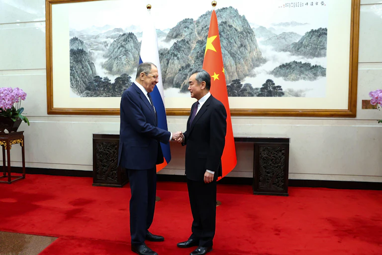 Lavrov and Yi shake hands in Beijing to discuss the ongoing relationship between Russia and China.