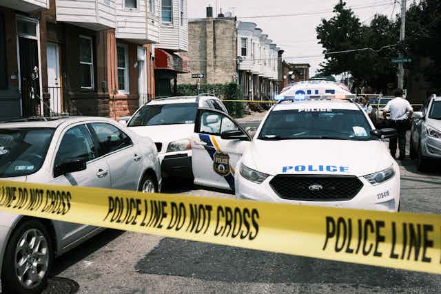 Police tape blocks a street where a person was shot in the Kensington neighborhood of Philadelphia