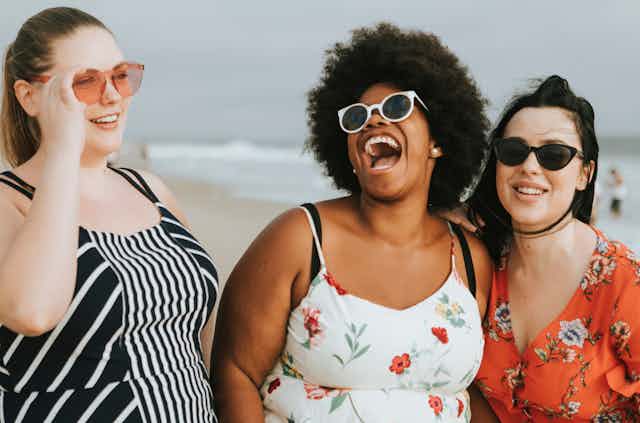 Three women smiling outdoors