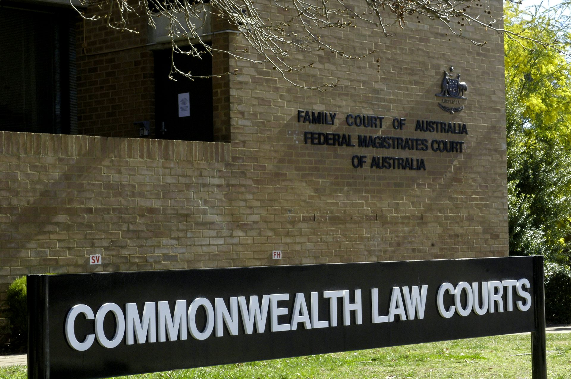 The exterior of a brick building with a sign reading 