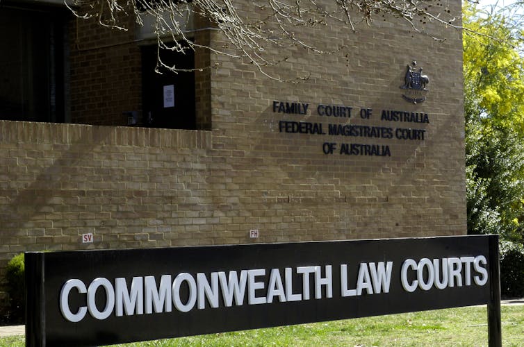 The exterior of a brick building with a sign reading
