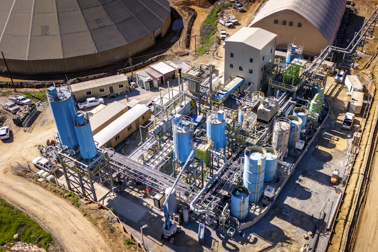 aerial shot of cement production plant, lots of outbuildings, industrial units