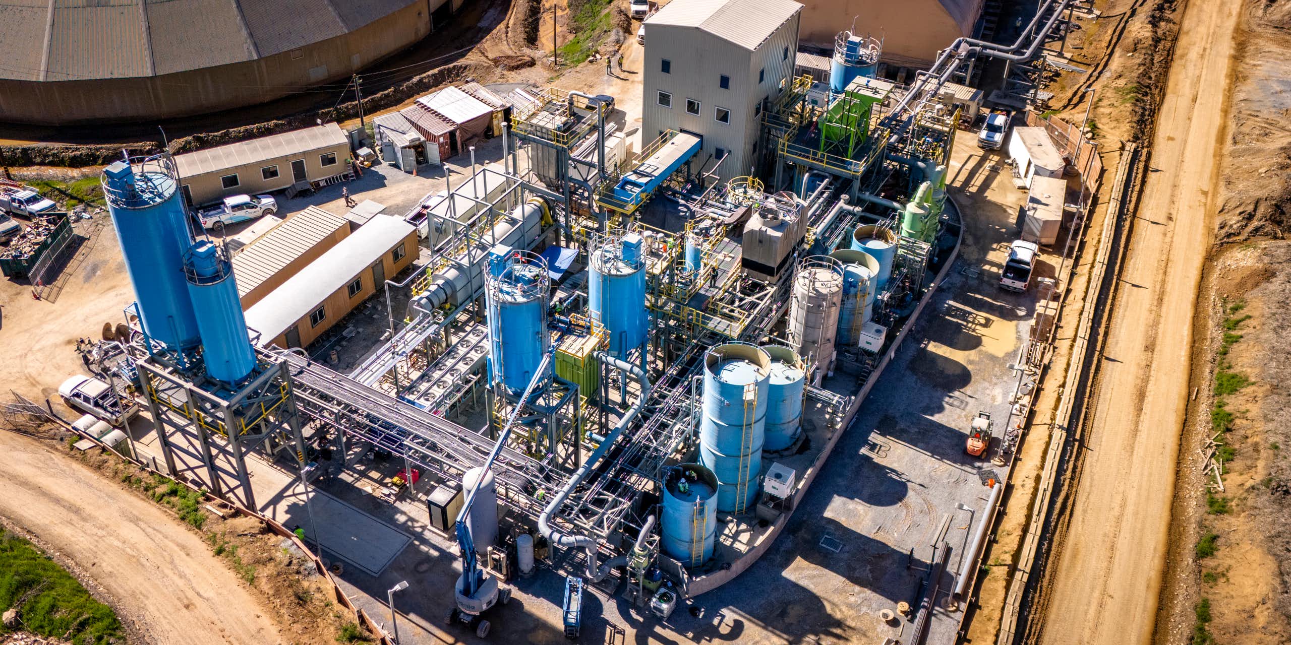 aerial shot of cement production plant, lots of outbuildings, industrial units