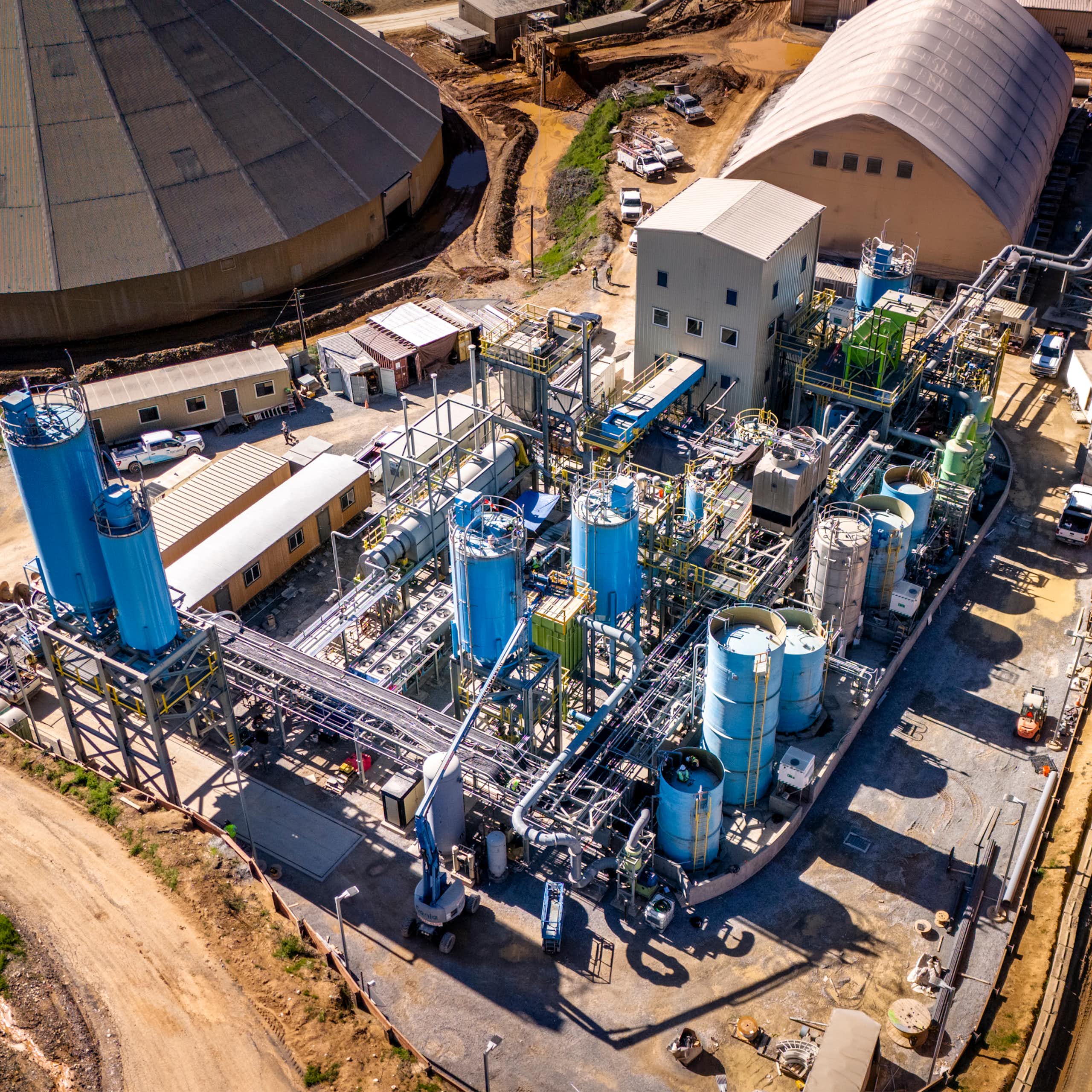 aerial shot of cement production plant, lots of outbuildings, industrial units