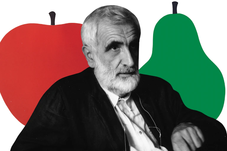 Enzo Mari in front of an apple and pear cutout.