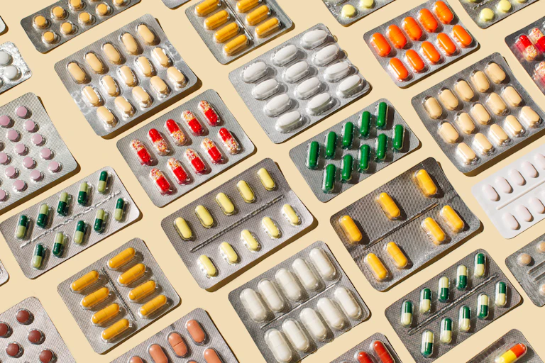 Array of multicolored pills in blister packs
