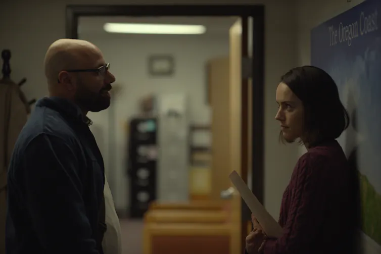 Dave Merheje and Daisy Ridley in a corridor