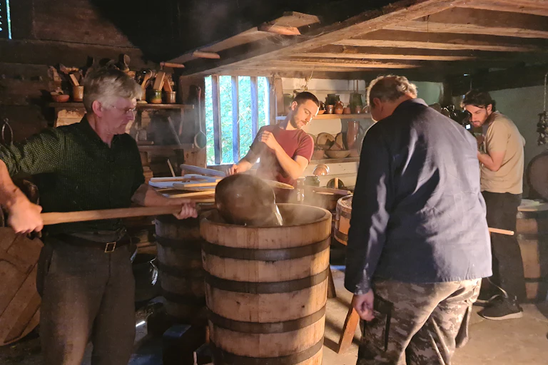 Adding water to the mash vat as part of the brewing process.