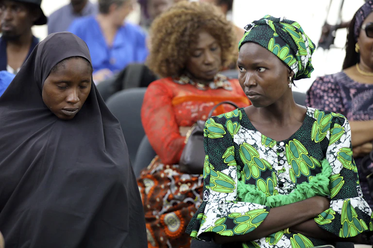 close-up of three women sitting in an audience