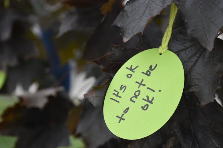 A handwritten tag reading 'It's OK to no be OK!'