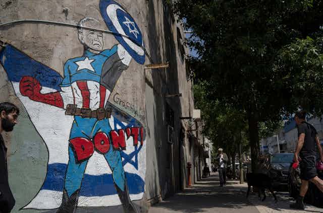 A mural in Tel Aviv depicts US president Joe Biden as a superhero defending Israel.
