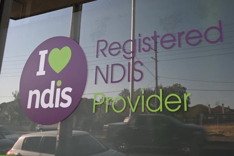 Window with printed lettering that reads: Registered NDIS provider