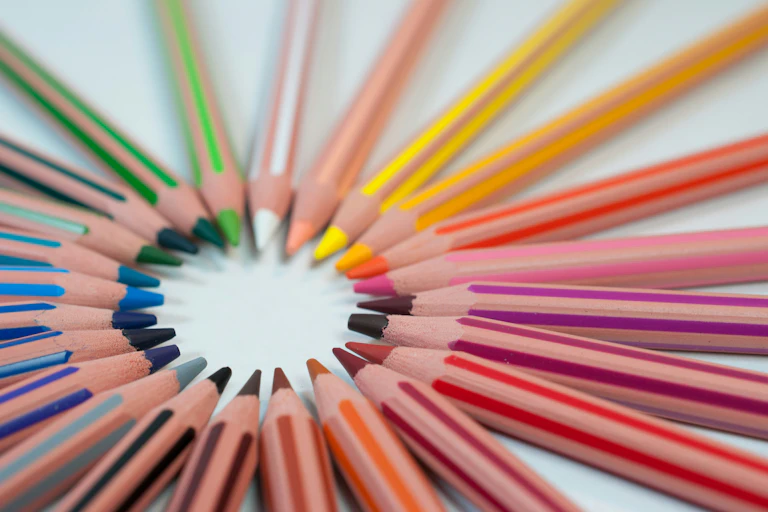Coloured pencils arranged in a circle.