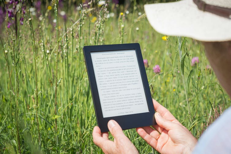 Man on Kindle in garden