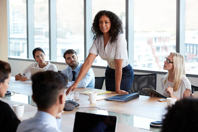 Female leader speaking to a group of colleagues