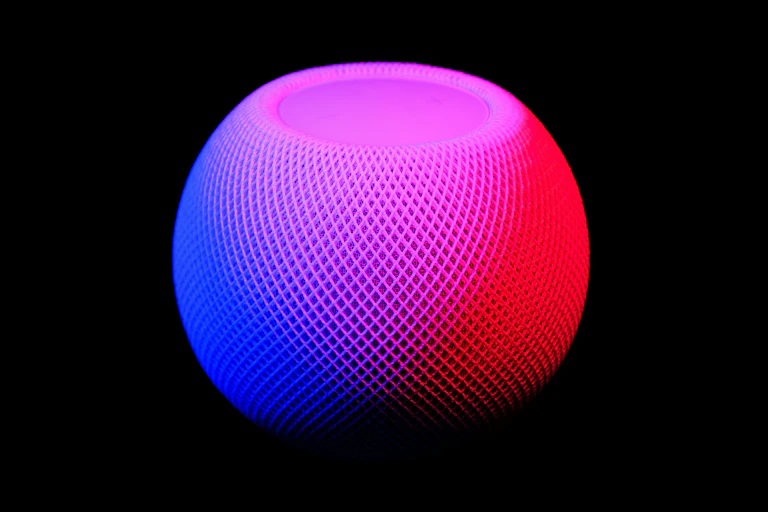 A round mesh pod in blue and red lighting on a black background.