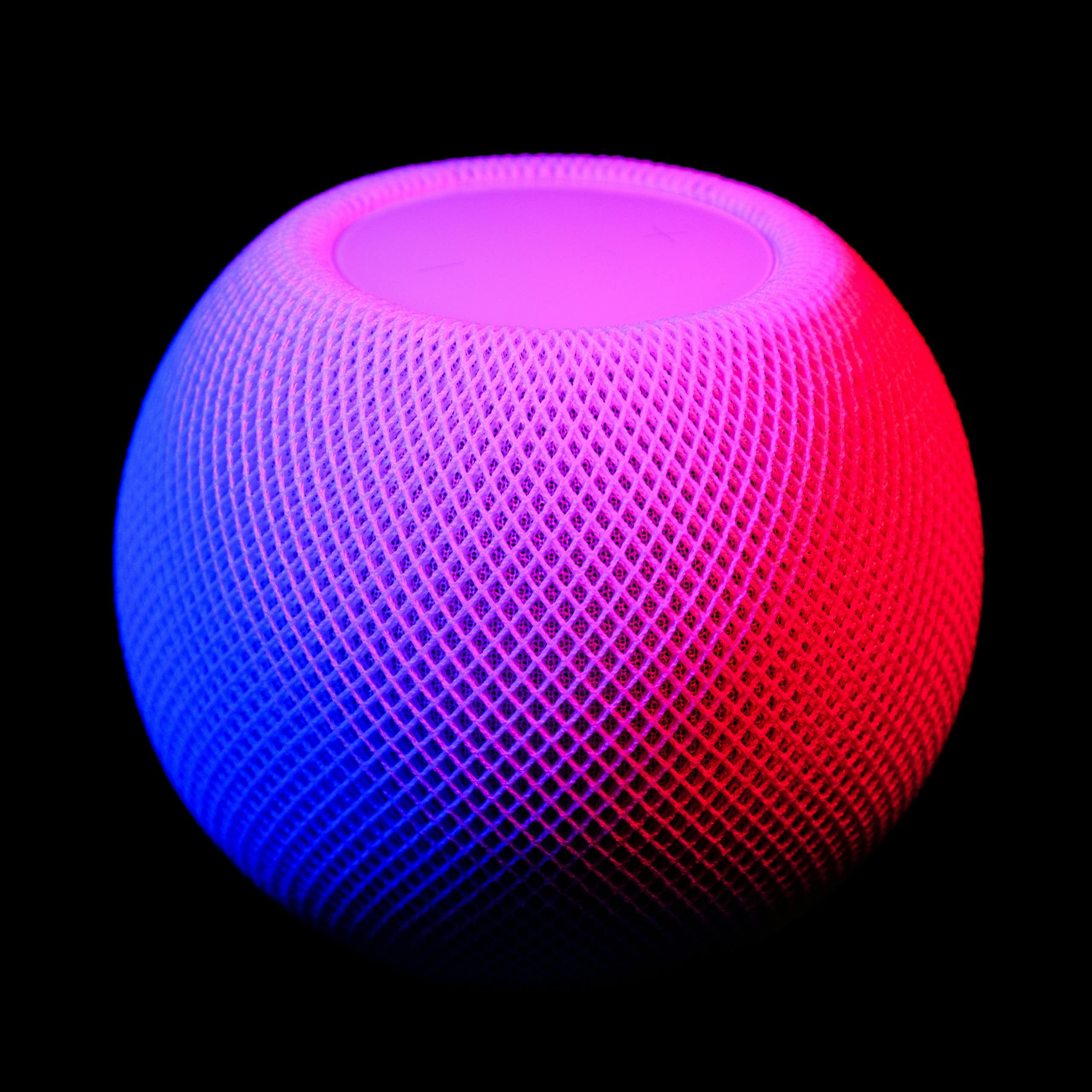 A round mesh pod in blue and red lighting on a black background.