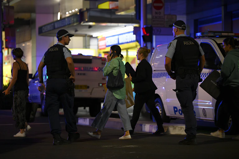 Members of the public being guided by police