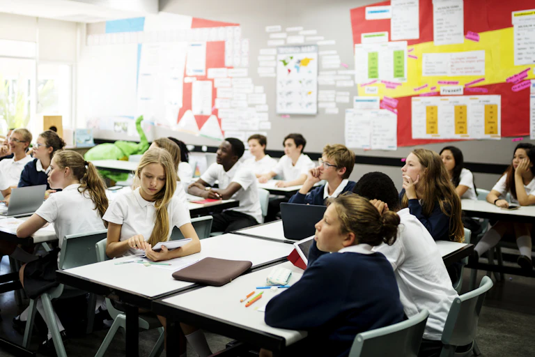 School students wearing uniform sitting in classroom