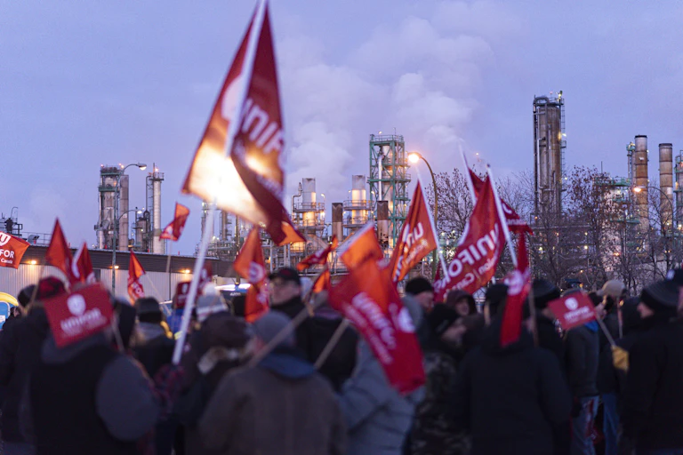 A group of people holding signs and flags.