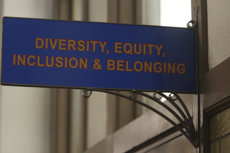 A blue sin above a door reading: diversity equity inclusion and belonging.