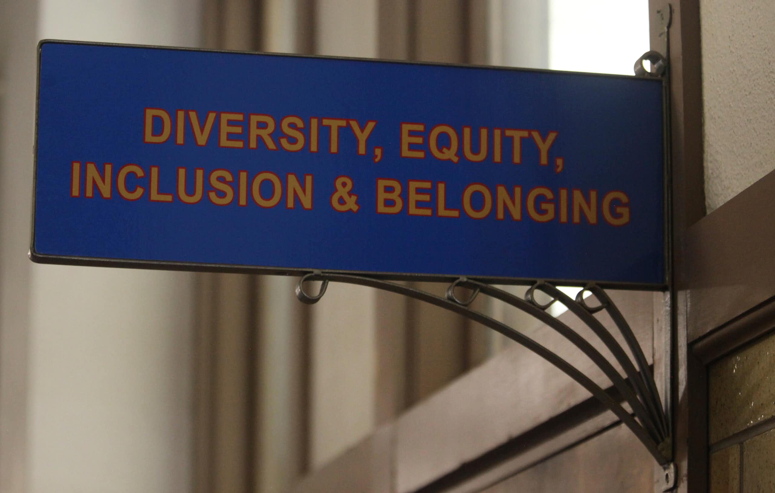 A blue sin above a door reading: diversity equity inclusion and belonging.