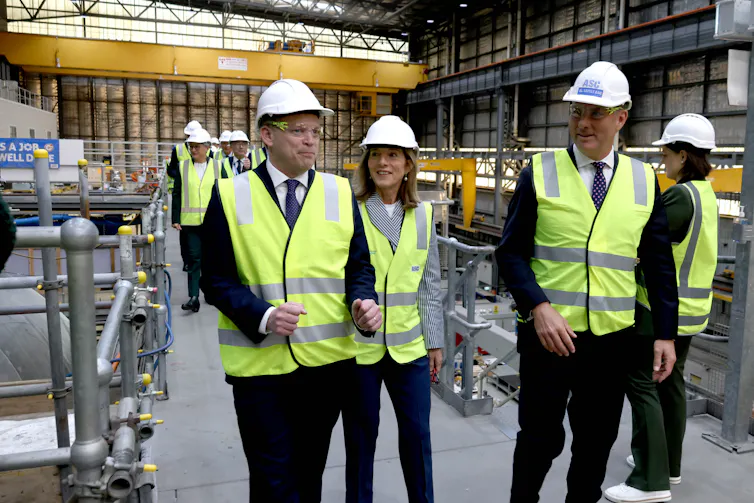 Richard Marles visits a shipyard with British and American officials.