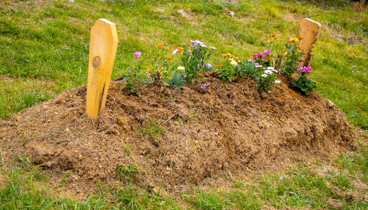 A grave sits on some land.