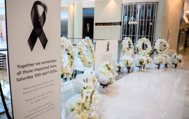 A floral memorial is laid at Westfield Bondi Junction shopping centre