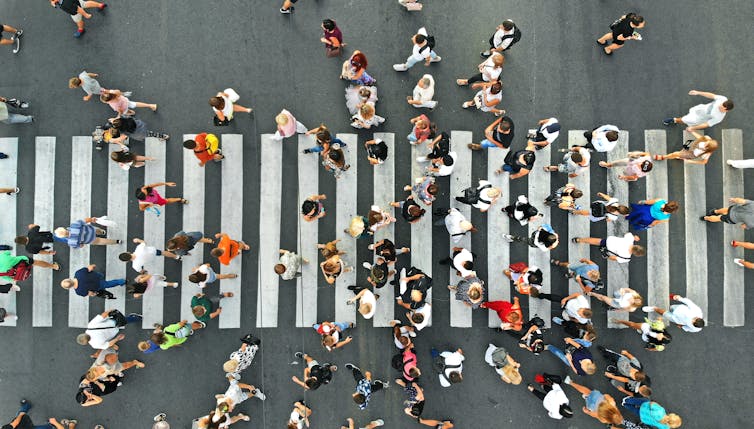 Aerial view people crossing pedestrian crosswalk