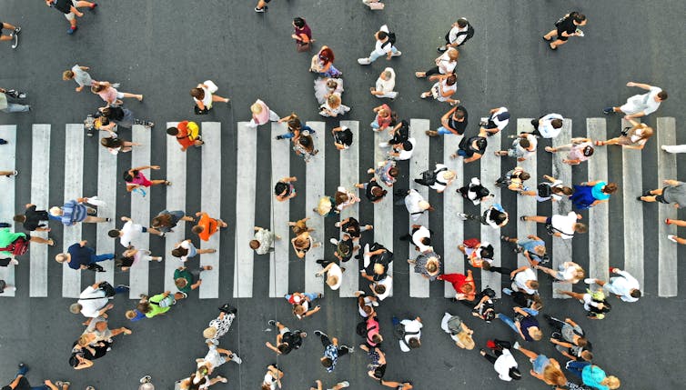 Aerial view people crossing pedestrian crosswalk