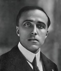 Head and shoulders portrait of a man in suit and tie