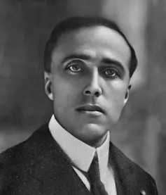 Head and shoulders portrait of a man in suit and tie