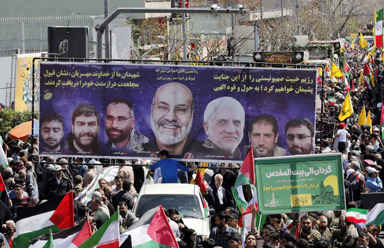 Iranian mourners carry banners of the seven seven members of the Islamic Revolutionary Guard Corps (IRGC) who were killed in Israel's April 1 airstrike on Iran's embassy in Syria.