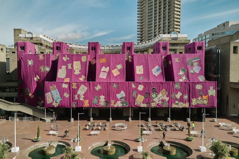 The concrete Barbican museum wrapped in purple fabric
