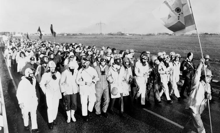 Protesters in nuclear hazard suits