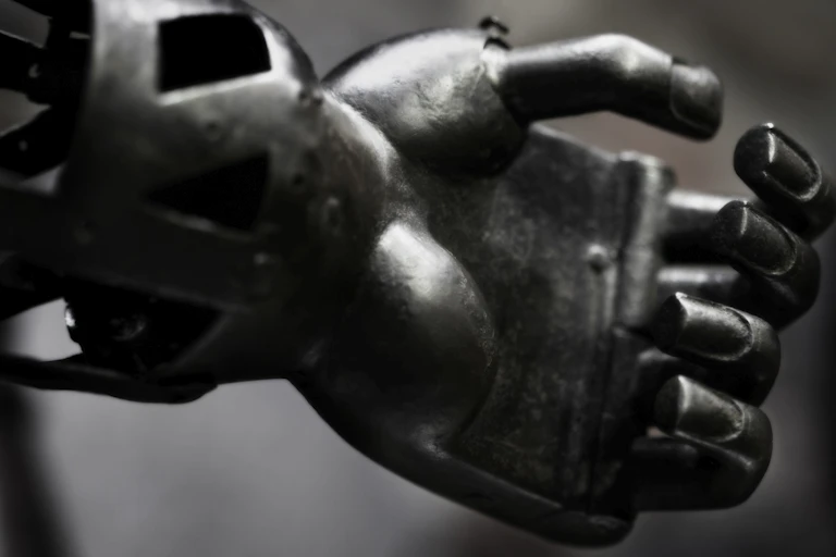 Close-up image of an iron hand, fingers loosely curled