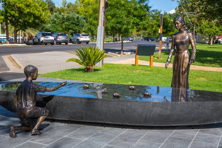 A monument of a woman and a child depicts the Vietnamese 'boat people' in Adelaide, Australia.