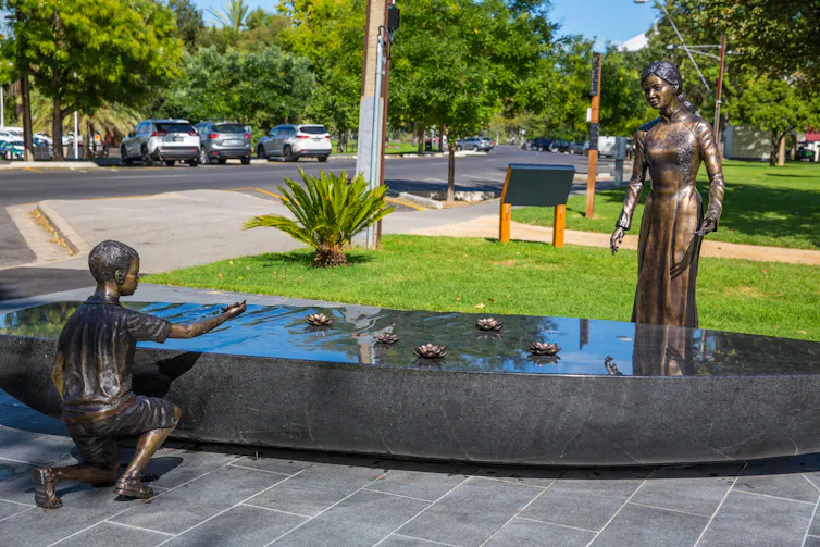 A monument of a woman and a child depicts the Vietnamese 'boat people' in Adelaide, Australia.