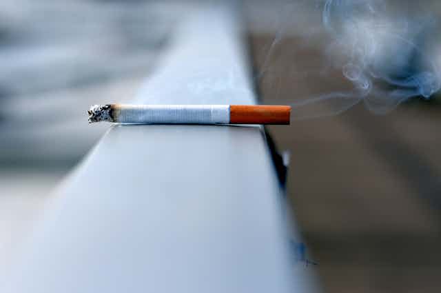 A cigarette sitting on a ledge.