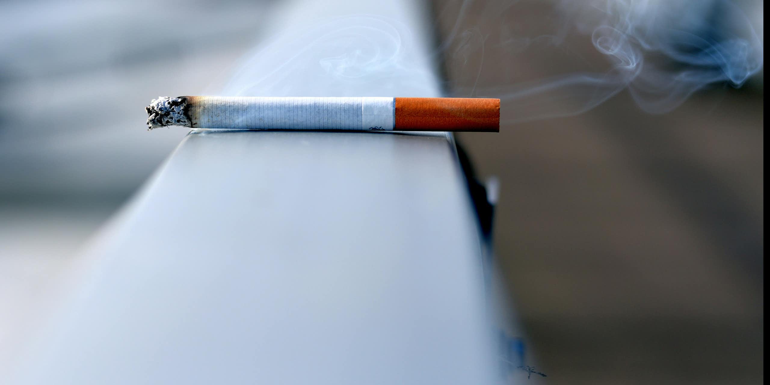A cigarette sitting on a ledge.