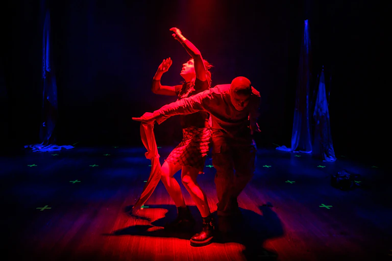 Two actors in red light