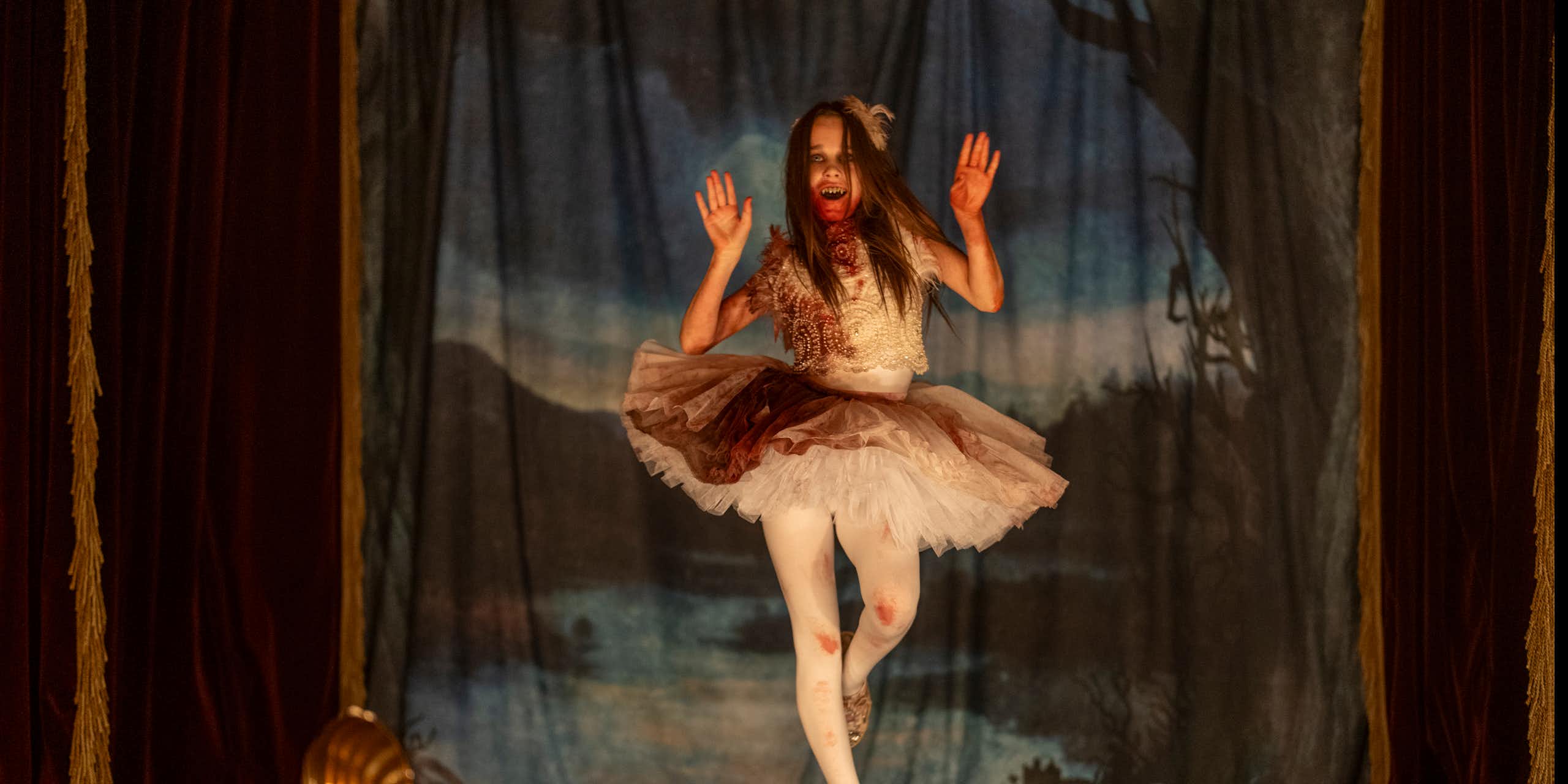 Young girl in a tutu covered in blood